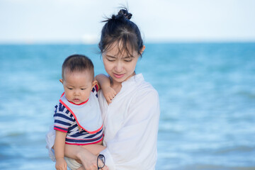 Fototapeta na wymiar baby and mother on the beach