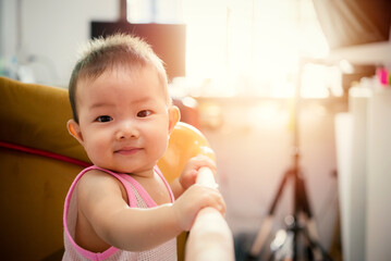 Cute little baby Standing smile in cradle at home
