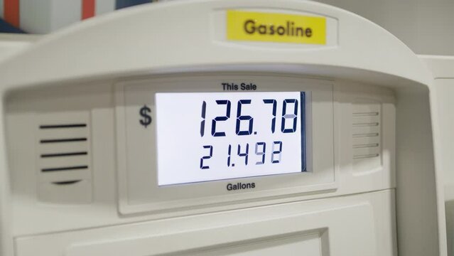 Detailed view of a car refueling with close-up shot of a display at gas station. Drastic prices rising on fuel business concept, increasing cost of living. High quality 4k footage