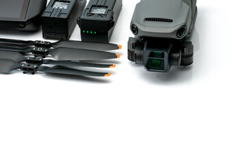 Drone and propeller blades on blur drone LiPo rechargeable battery. UAV or unmanned aerial vehicle. Quadcopter drone aircraft with a digital camera. Drone accessories. UAV carbon fiber propellers.