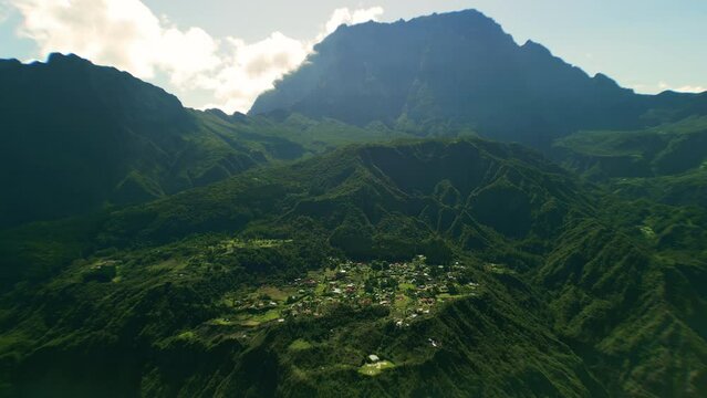 With the Piton del Neige in the background drone slowly flies close to La Nouvelle in the Cirque du Mafate in La Reunion