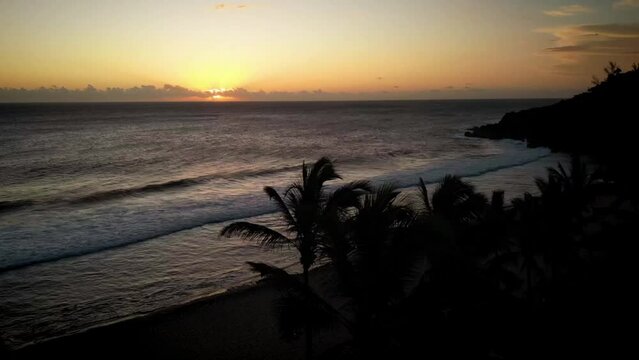 Timelapse Of Drone Standing Still Over The Ocean As The Sun Sets And Palm Trees Move In The Wind Warm Colors Of The Sun