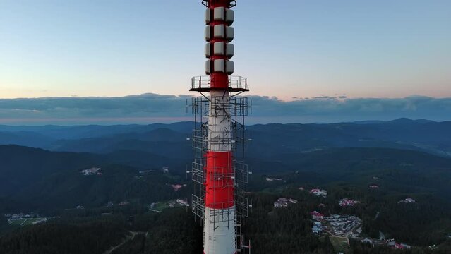 Tower Snezhana on peak of Snezhana covered with spruce forests in Rhodope mountains