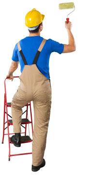 House painter is painting white wall, Back view from behind Young full length man in blue overalls with painting tool