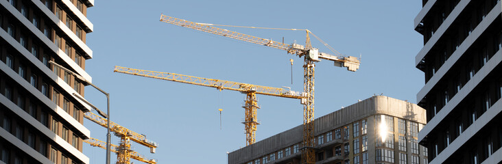 Unloading cargo and loading cargo with a crane. Crane boom and hook against the sky with engineering details and knots.