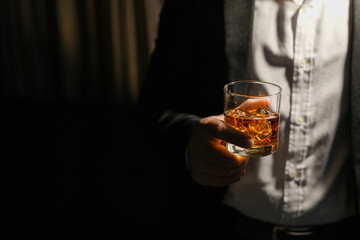 Closeup businessmen holding a glass of whiskey