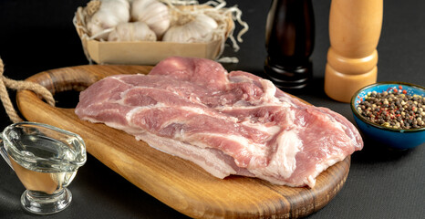 The concept of cooking meat. The chef cook salt on the cooked steak on a black background, a place under the logo for the restaurant menu. food background image, copy space text