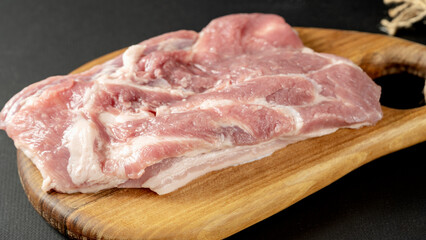 The concept of cooking meat. The chef cook salt on the cooked steak on a black background, a place under the logo for the restaurant menu. food background image, copy space text