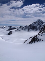 Fototapeta na wymiar Fox glacier in New Zealand, mountain peaks with clouds over Glaciers
