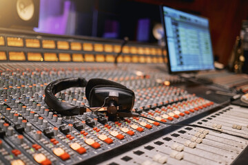 Sound board, music and production with headphones in recording studio with creativity and audio equipment. Mixing console, dj and technology with art, amplifier and produce song with entertainment