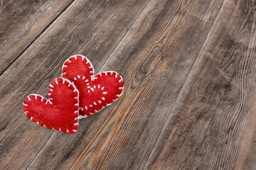 Multicolored wool hearts on the wooden desk