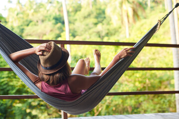 Woman relaxing in hammock in vacation. Woman relaxing in hammock in vacation on tropical island in Thailand.