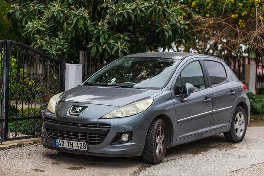Side, Turkey &ndash; February 04 2023:   gray Peugeot 308    is parked  on the street on a warm day against the backdrop of a   park, fence