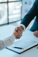 Shaking hands after sign a contract, realtor suggestion a new house model assisting client to sign contract agreement with insurance to happy living building, concerning mortgage loan offer