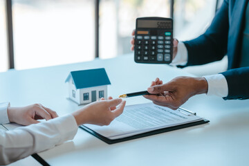 give a pen to sign a contract, realtor suggestion a new house model assisting client to sign contract agreement with insurance to happy living building, concerning mortgage loan offer