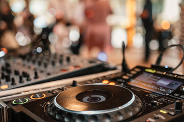 Fototapeta na wymiar DJ Spinning. mixing and scratching in a night club. DJ playing music at mixer. Closeup. Party. Dj playing music on rave party in nightclub. Disc jockey mix