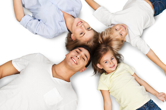 Portrait of happy family lying on floor in their new house