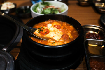 ‘Kimchi Jjigae’ or Kimchi Soup with Soft Tofu or Korean Kimchi Stew - Korean Food Traditional Style, (selective focus).