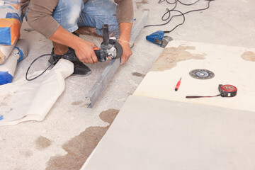 Worker using saw with circular diamond blade for metal stud cutting indoors, closeup. Tiles...
