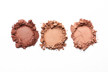 Different crushed eye shadows on white background, top view