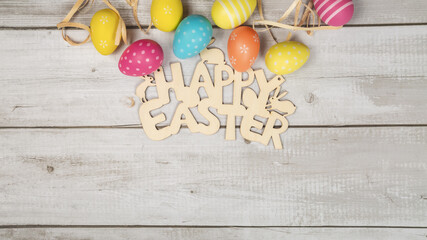 Art Happy Easter concept. Frame of Easter eggs, greeting card and on white wooden background. Flat lay, top view, copy space.