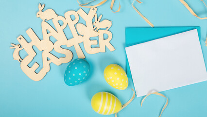 greeting card with text happy easter. multicolored easter eggs on blue background