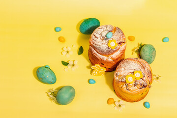 Easter cake Cruffin or sweet bread kulich and traditional painted eggs. Baking and cherry flowers