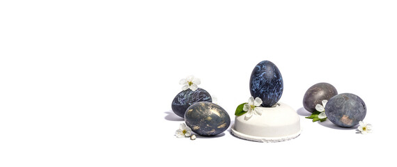 Easter egg on a beton stand isolated on white background. Traditional symbol, blooming cherry