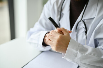 A stressed and determined female doctor making clenched fits, having a serious topic with patient