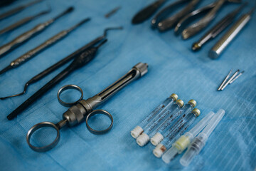 Photo of a set of steril dentistry tools or instruments lying on a light blue table