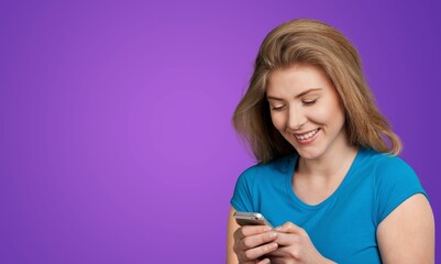 shocked Smiling young woman posing with phone