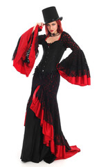 portrait of beautiful red haired woman wearing long black fantasy vampire costume gown, isolated pose on  studio background.