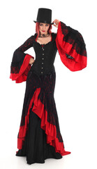 portrait of beautiful red haired woman wearing long black fantasy vampire costume gown, isolated pose on  studio background.