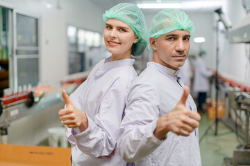 portrait quality supervisor or food or beverages technician team thumbs up quality control food or...