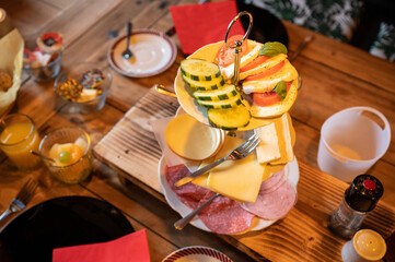 Selection of cold cuts and healthy salads at a decorated breakfast table
