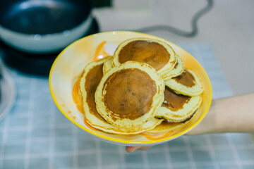small pancake isolated on orange dish