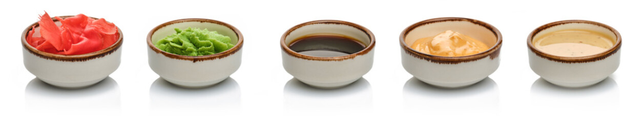 Japanese condiment for sushi. Soy sauce, wasabi, pickled ginger, sesame sauce and pickled radish, classic sauces in traditional Japanese cuisine