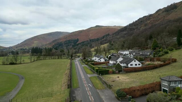 Cinematic cumbrian aerial lndscape, Aerial view of motorbikes moving down a country road in Grasmere. UK