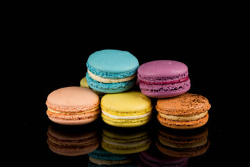 Colorful macaroon over black background