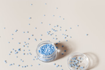 Festive Nail Designs, elements for nails decor, blue stars in glass box, stars for diy nail art in jar on beige background copyspace. Minimal style aesthetic template feminine blog, social media