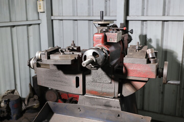 Close up metal lathe machine for polishing car disc brake at garage. Maintenance automotive and inspecting vehicle part concept