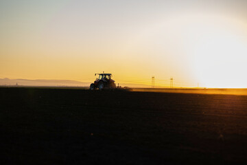 Fototapeta na wymiar Farmer preparing his field in a tractor