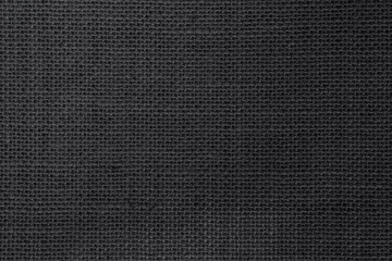 Black hemp rope texture background. Haircloth wale black dark cloth wallpaper. Rustic sackcloth canvas fabric texture in natural.
