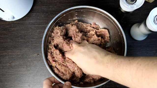 cooking meatballs mixing forcemeat overhead in bowl
