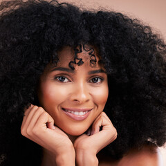 Fototapeta na wymiar Hair, beauty and portrait of black woman with afro on brown background for wellness, shine and natural glow. Salon, luxury treatment and face zoom of happy girl with curly hairstyle, growth and smile