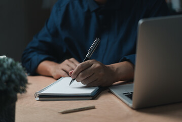 Businessperson reading and writing on book.education studying knowledge development and cognition...