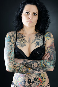 Beautiful gothic woman with many large tattoos on her body