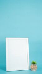 empty poster frame mockup set on a wooden table and small flower vase. design interior