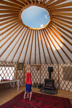 A woman doing yoga in a yurt in Mayday, Colorado.