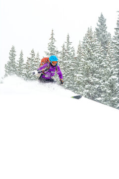 A woman backcountry skiing  above Red Mountain Pass, Silverton, Colorado.